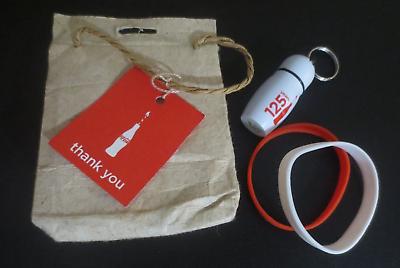 Coca Cola 125th Anniversary Gift Bag ear plugs in case and 2 Rubber Bracelets $7.50